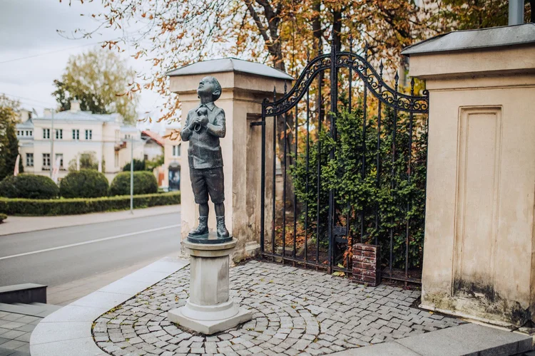 A Boy with a Shoe Statue