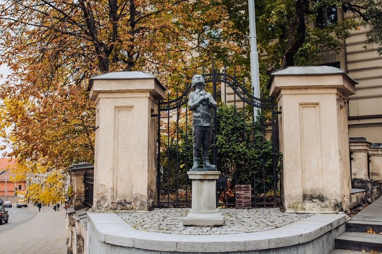 A Boy with a Shoe Statue